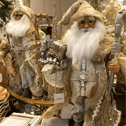 golden santa figurines in the gold and glamour room of christmas land 2025 at dewayne's
