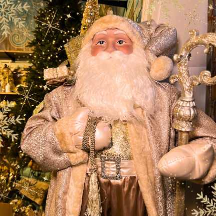 Decorative golden santa  in the gold and glamour room in christmas land 2025 at dewayne's