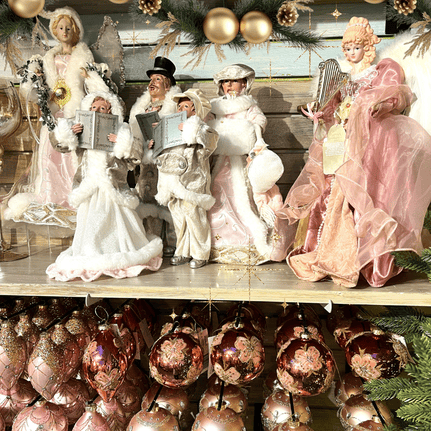 Decorative caroler figurines and ornaments in the gold and glamour room in christmas land 2025 at dewaynes