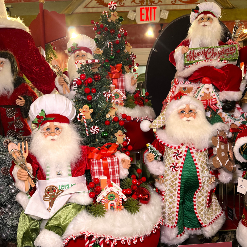 Decorative display of Santa Claus figurines with a Christmas tree in the Timeless Treasures Room in Christmas Land 2025 at Dewayne's