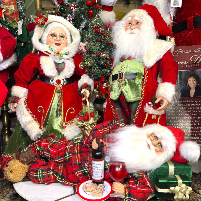 Decorative Christmas figures including Santa Claus and Mrs. Claus with a bottle of wine and wine glass in the Timeless Treasures Room in Christmas Land 2025 at Dewayne's