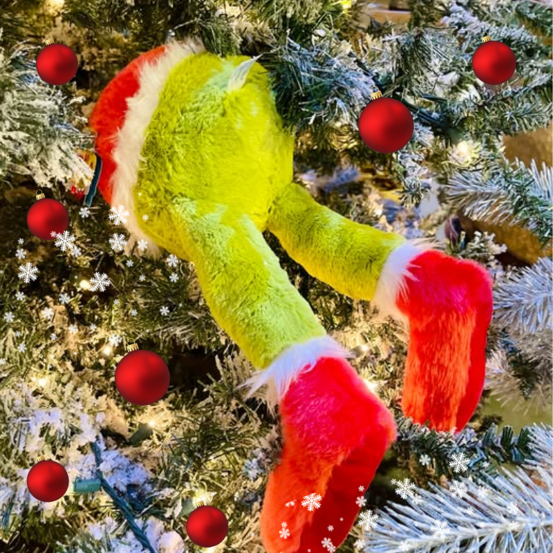 Grinch Plush diving into christmas tree in santa's workshop in christmas land 2025 at dewayne's