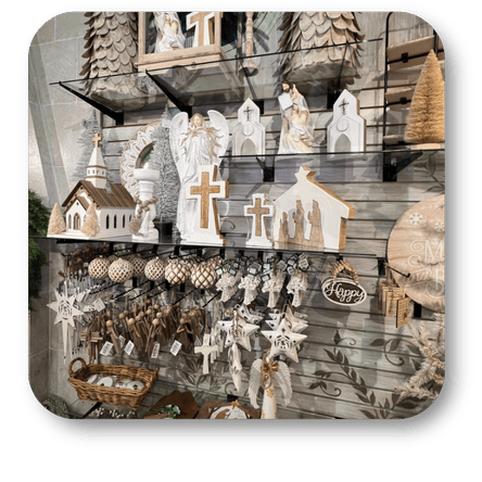 Decorative items including small buildings, crosses, and angels in the moments of thyme room in christmas land at Dewayne's in Selma, NC minutes from Raleigh, Cary, Clayton, Garner, Smithfield, Goldsboro