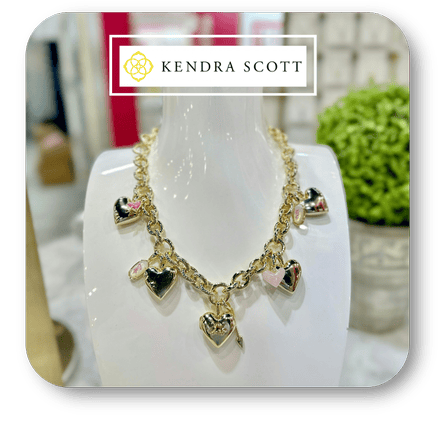Necklace with heart-shaped charms on a white stand, branded with Kendra Scott Necklaces in the boutique at Dewayne's in Selma, NC minutes from Raleigh, Cary, Clayton, Garner, Smithfield, Goldsboro