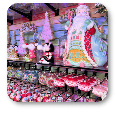 Display of Christmas-themed decorations including a large Santa figure and various ornaments in the Kringle's Kitchen room in christmas land 2025 at Dewayne's in Selma, NC minutes from Raleigh, Cary, Clayton, Garner, Smithfield, Goldsboro