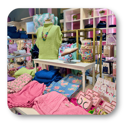 Display of ladies casual clothing and accessories in a store with a green sweater on a mannequin  in the boutique at Dewayne's in Selma, NC minutes from Raleigh, Cary, Clayton, Garner, Smithfield, Goldsboro
