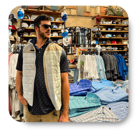 Man standing in a clothing store with shelves and racks of clothes in the background in the men's shoppe at Dewayne's in Selma, NC minutes from Raleigh, Cary, Clayton, Garner, Smithfield, Goldsboro