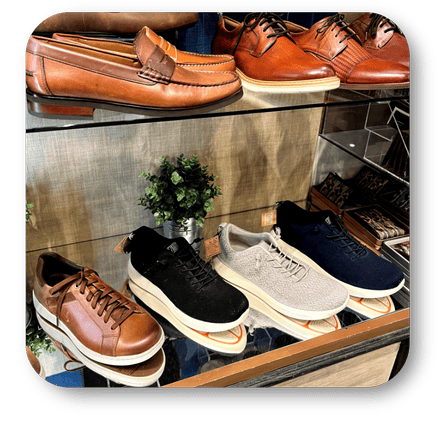 Display of various shoes including loafers, sneakers, and Florsheim dress shoes in the men's shoppe at Dewayne's in Selma, NC minutes from Raleigh, Cary, Clayton, Garner, Smithfield, Goldsboro