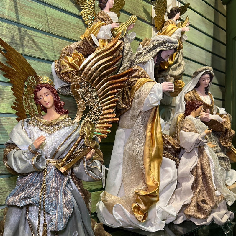 Decorative angel figurines with gold and white  in the moments of thyme room in christmas land 2025 at dewayne's
