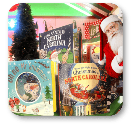 Collection of Christmas-themed books with Santa Claus and Christmas trees  in santa's workshop at Dewayne's in Selma, NC minutes from Raleigh, Cary, Clayton, Garner, Smithfield, Goldsboro