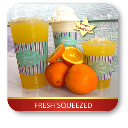Frozen orangeade drinks with oranges on a white surface in the sweet shop at Dewayne's in Selma, NC minutes from Raleigh, Cary, Clayton, Garner, Smithfield, Goldsboro