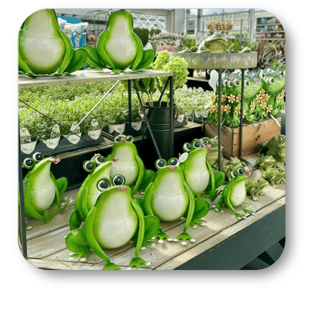 Green playful metal frogs for outdoor charm  in the greenhouse atrium at Dewayne's in Selma, NC minutes from Raleigh, Cary, Clayton, Garner, Smithfield, Goldsboro 