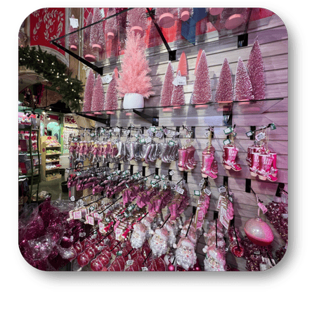 Display of pink Christmas decorations and ornaments  in the wrapped in red room in christmas land at Dewayne's in Selma, NC minutes from Raleigh, Cary, Clayton, Garner, Smithfield, Goldsboro