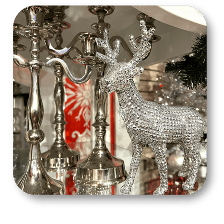 holiday Silver deer decor and silver candle holders in the wrapped in red room in christmas land at Dewayne's in Selma, NC minutes from Raleigh, Cary, Clayton, Garner, Smithfield, Goldsboro