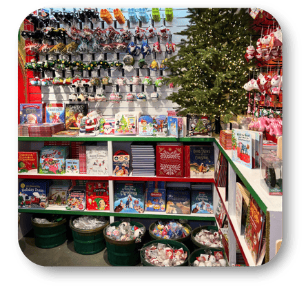 Various christmas toys, books and a Christmas tree in the background  in santa's workshop at Dewayne's in Selma, NC minutes from Raleigh, Cary, Clayton, Garner, Smithfield, Goldsboro