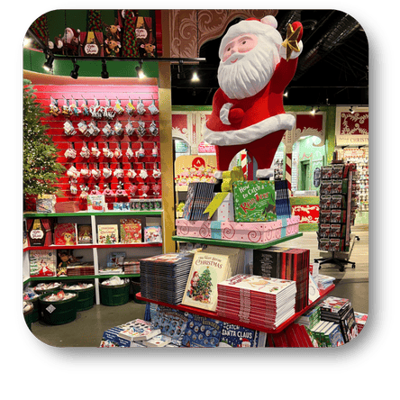Santa statue among kids christmas books and ornaments in santa's workshop at Dewayne's in Selma, NC minutes from Raleigh, Cary, Clayton, Garner, Smithfield, Goldsboro