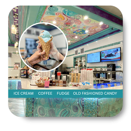 Ice cream shop interior with a person holding an ice cream cone, colorful ceiling, and menu board in the sweet shop at Dewayne's in Selma, NC minutes from Raleigh, Cary, Clayton, Garner, Smithfield, Goldsboro