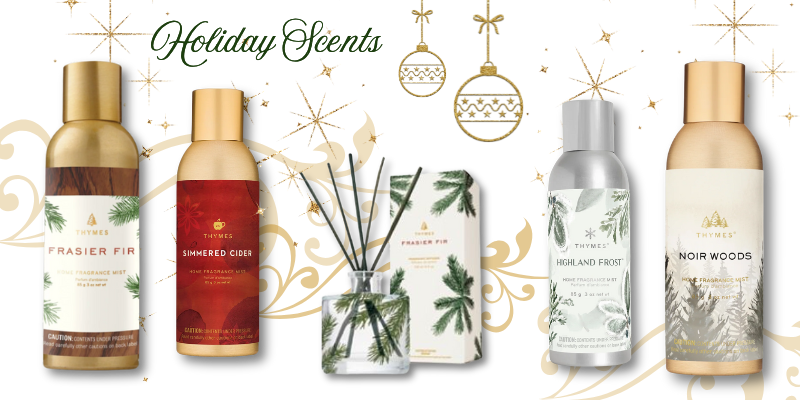 Collection of Thymes holiday-themed diffusers and reed diffusers on a decorative background with ornaments at Dewayne's in Selma, NC minutes from Raleigh, Cary, Clayton, Garner, Smithfield, Goldsboro