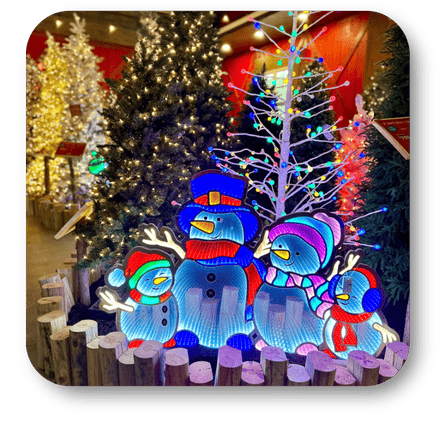 Colorful outdoor Christmas decorations including a snowman, birds, and trees with lights Decorated Christmas trees at Dewayne's in Selma, NC minutes from Raleigh, Cary, Clayton, Garner, Smithfield, Goldsboro