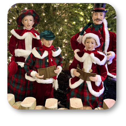 Caroling family figurines in front of a Christmas tree at Dewayne's in Selma, NC minutes from Raleigh, Cary, Clayton, Garner, Smithfield, Goldsboro