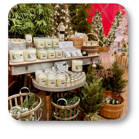 Display of candles and gift bags with a person in a Santa hat in a festive setting at Dewayne's in Selma, NC minutes from Raleigh, Cary, Clayton, Garner, Smithfield, Goldsboro