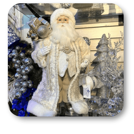 Decorative Santa Claus figure with a bejeweled hat and coat, surrounded by Christmas decorations in Christmas Land at Dewayne's in Selma, NC minutes from Raleigh, Cary, Clayton, Garner, Smithfield, Goldsboro