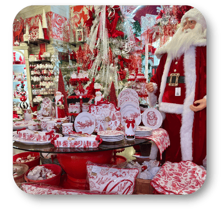 Decorative Christmas items including Santa Claus figure, red and white tableware, and festive decorations in the wrapped in red room in christmas land 2025 at Dewayne's in Selma, NC minutes from Raleigh, Cary, Clayton, Garner, Smithfield, Goldsboro