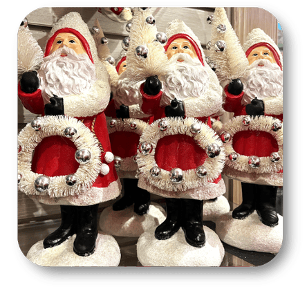 Decorative Santa Claus figures with wreaths in the wrapped in red room in christmas land 2025 at Dewayne's in Selma, NC minutes from Raleigh, Cary, Clayton, Garner, Smithfield, Goldsboro
