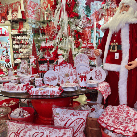 Decorative Christmas items including Santa Claus figure, red and white tableware, and festive decorations in the wrapped in red room in christmas land 2025 at Dewayne's in Selma, NC minutes from Raleigh, Cary, Clayton, Garner, Smithfield, Goldsboro