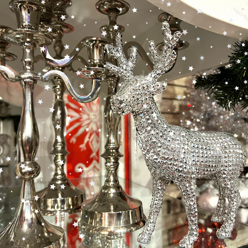 holiday Silver deer decor and silver candle holders in the wrapped in red room in christmas land 2025 at dewaynes