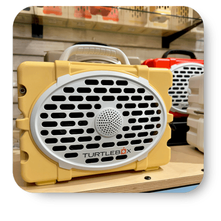 Yellow Turtlebox speaker on a wooden surface with shelves in the background in the gift shop at Dewayne's in Selma, NC minutes from Raleigh, Cary, Clayton, Garner, Smithfield, Goldsboro